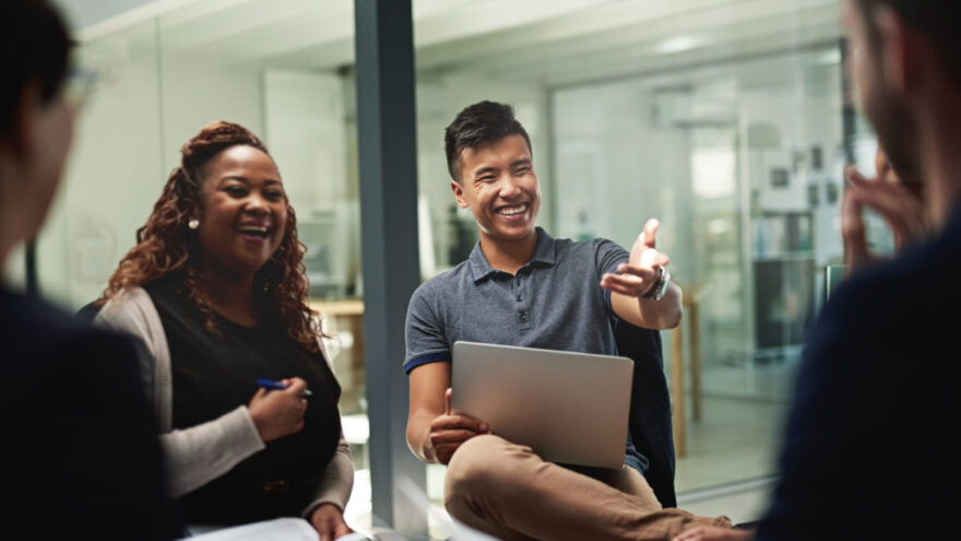 Shot of a group of businesspeople sitting in a circle while having a meeting